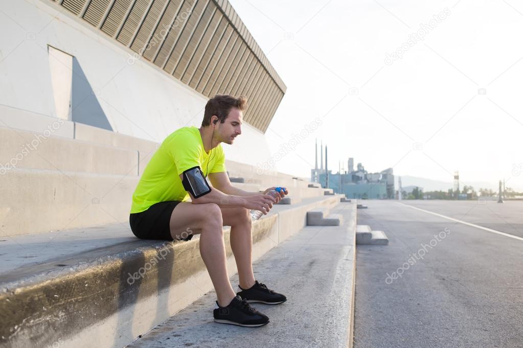 Male athlete sitting on paved stairs