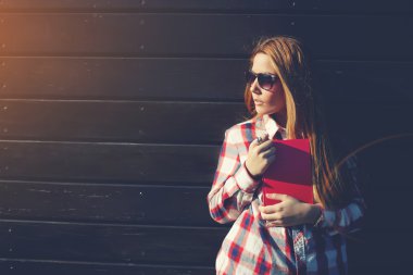 student standing on a wooden wall background