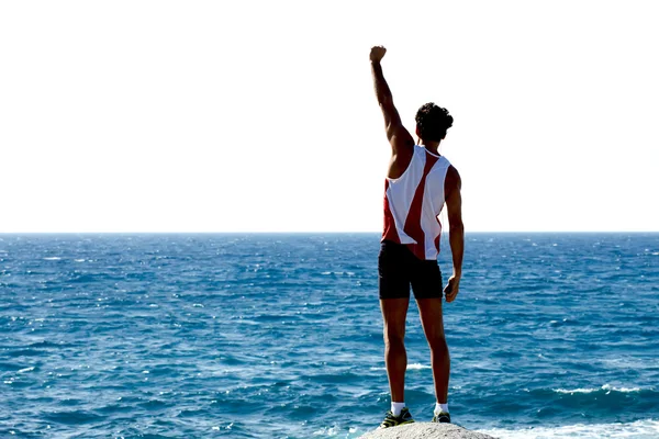 Sportsman standing on the rock — Stock Photo, Image