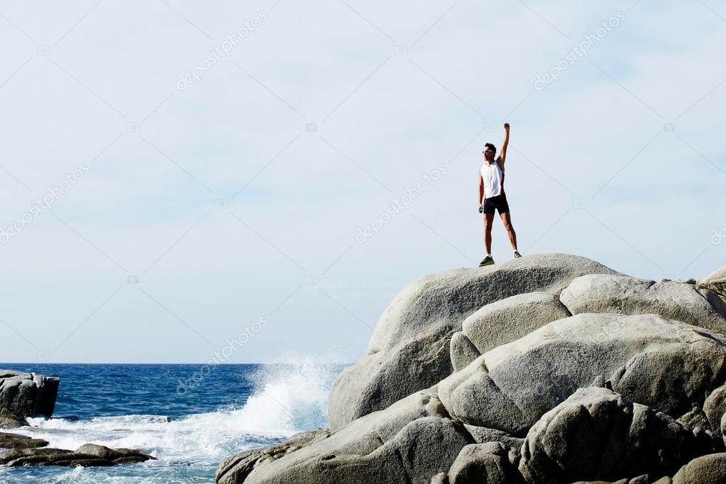 male runner standing on the rock