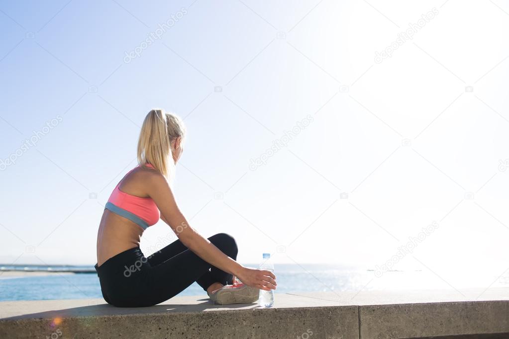 female runner taking break