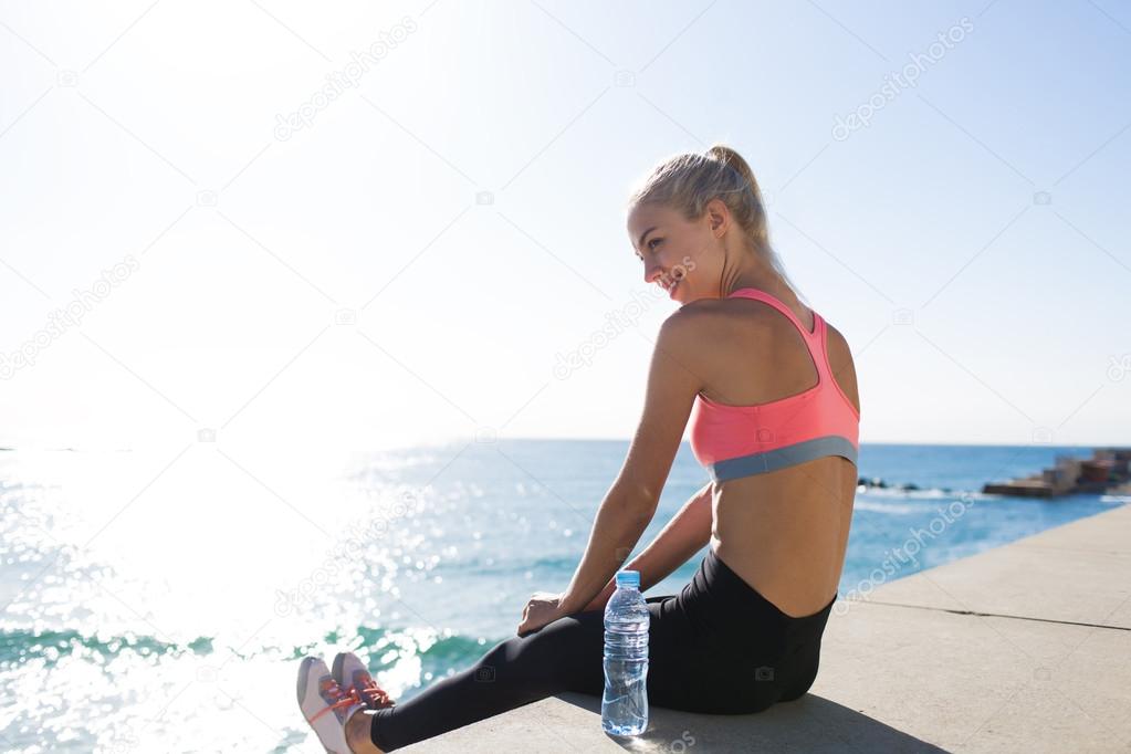 Sportswoman relaxing after fitness training