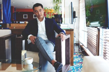 Businessman relaxing in cafe during break