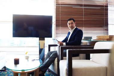 Asian businessman working on touch pad