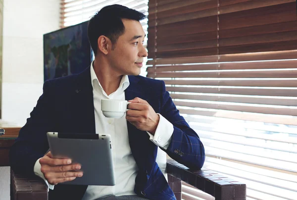 Young confident businessman enjoying coffee — Stock Photo, Image