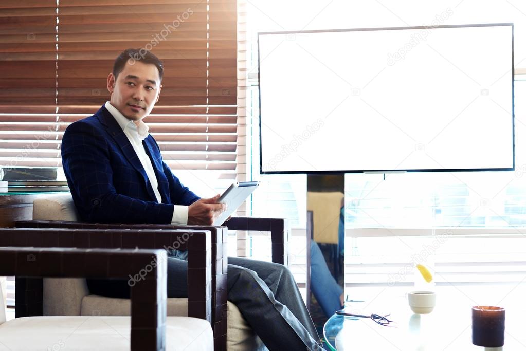 Asian businessman working on touch pad