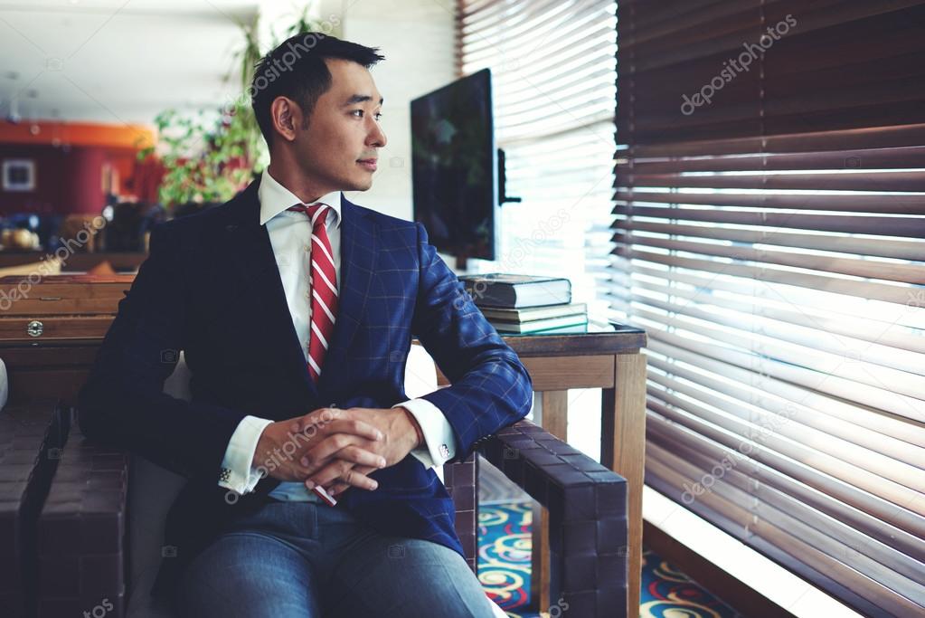 Asian businessman sitting in modern office