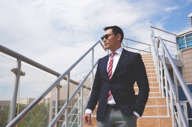 Young successful entrepreneur smoking a cigarette