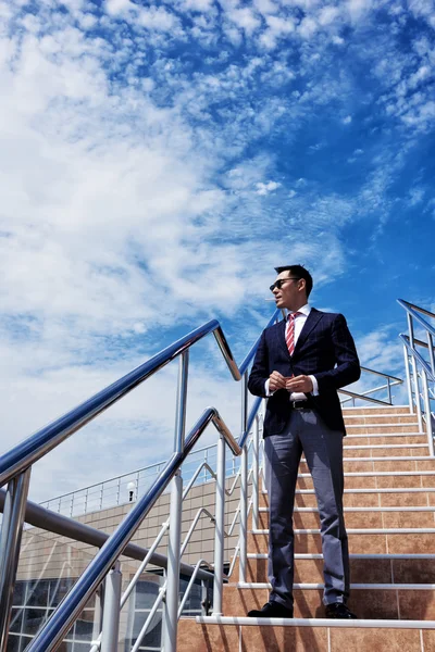 Young successful entrepreneur smoking a cigarette — Stock Photo, Image