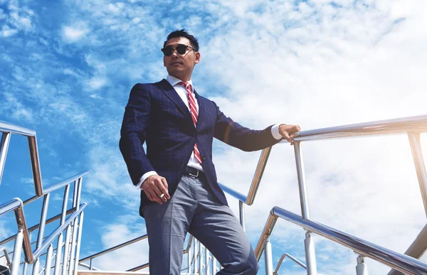 Young businessman smoking a cigarette