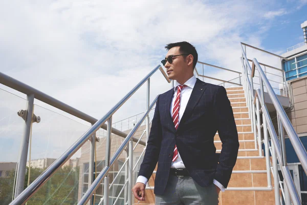 Young successful entrepreneur smoking a cigarette — ストック写真