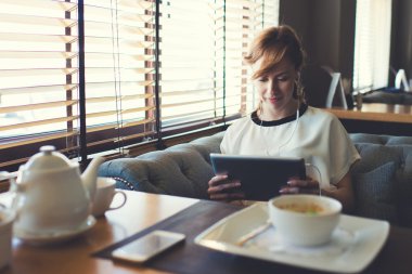 Woman have video conversation in cafe