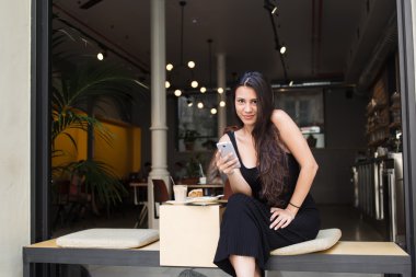 Charming  woman using her mobile phone