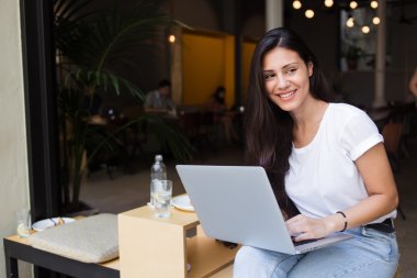 Young hipster girl working on her net-book