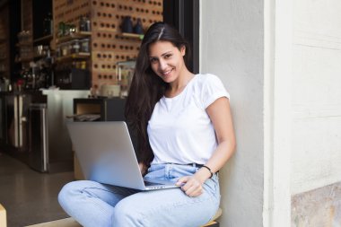 Young hipster girl working on her net-book