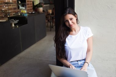 Young hipster girl working on her net-book
