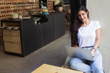 Young hipster girl working on her net-book