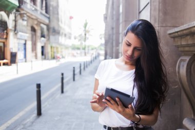 Woman with digital tablet in urban setting