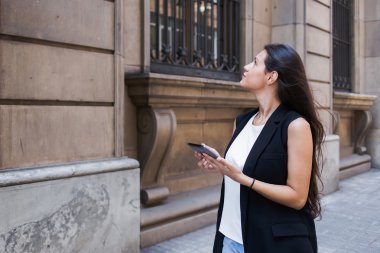 Woman with digital tablet in urban setting
