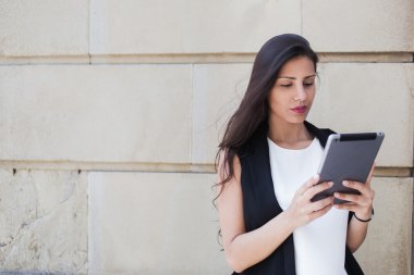 Woman with digital tablet in urban setting