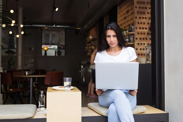 Young hipster girl working on her net-book — 스톡 사진