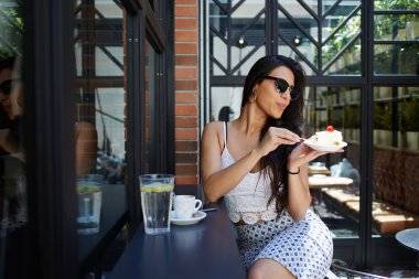 Woman enjoying breakfast in cozy cafe