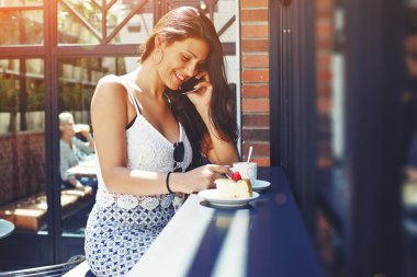 Charming woman talking on cell phone