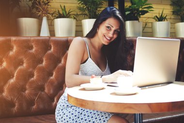 Woman working on her laptop in cafe