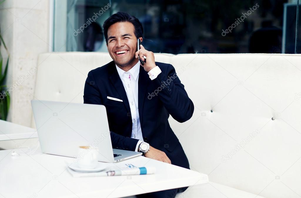 Smiling businessman talking on mobile phone