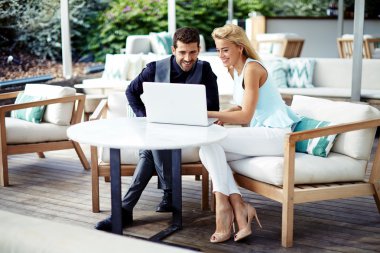Two business partners working in cafe