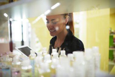 Female consultant recalculates cosmetic products