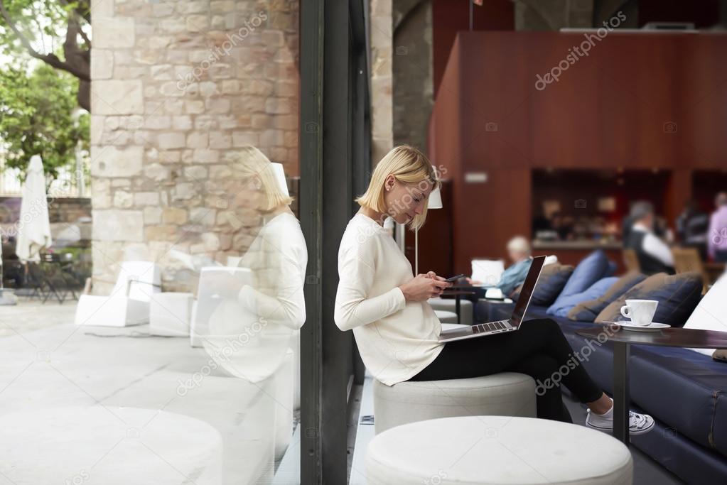 Young businesswoman working on smartphone