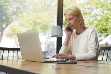 Confident female speaking on mobile phone