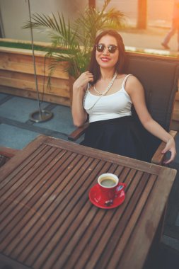 Moda güneş gözlüğü kafede oturan kadın