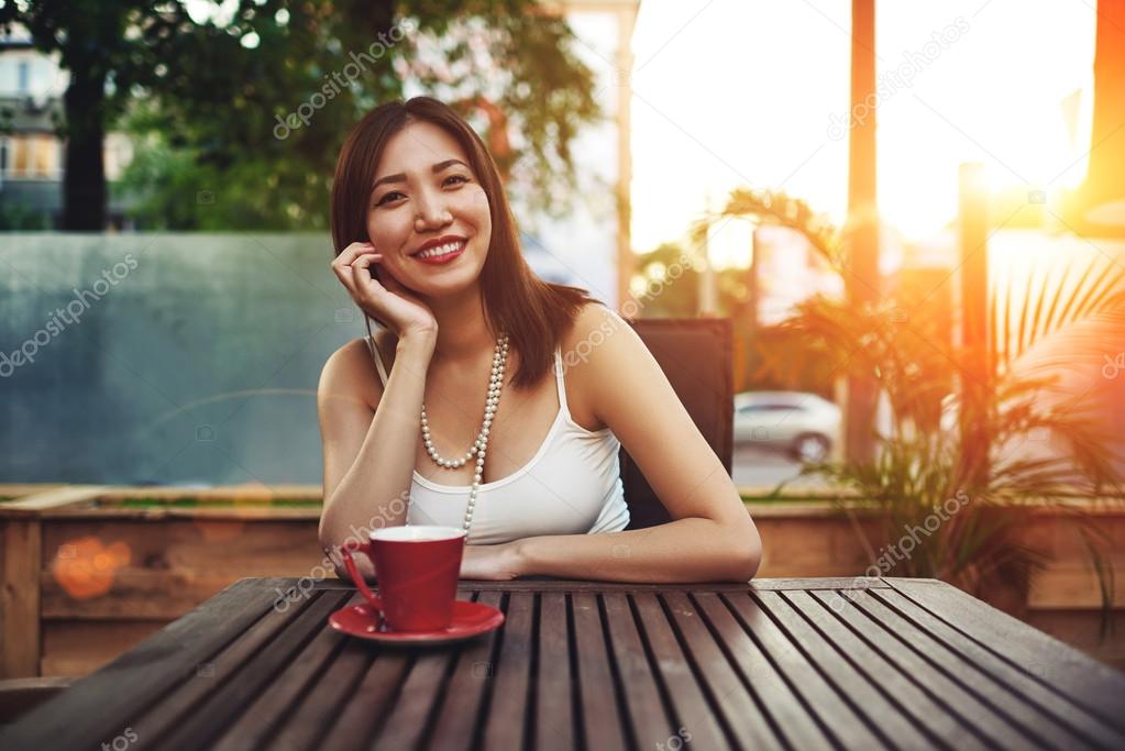 Attractive woman sitting in modern cafe