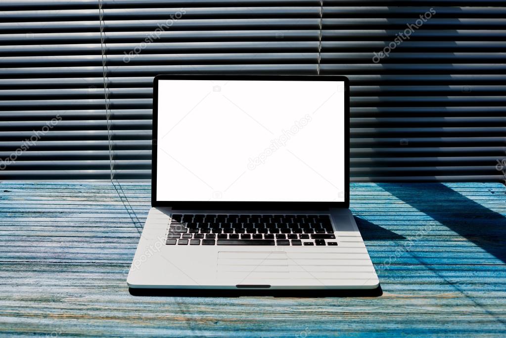 Office desktop with open laptop computer