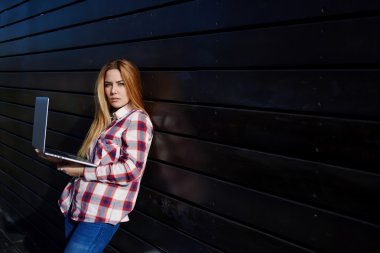 Hipster girl using her net-book outside