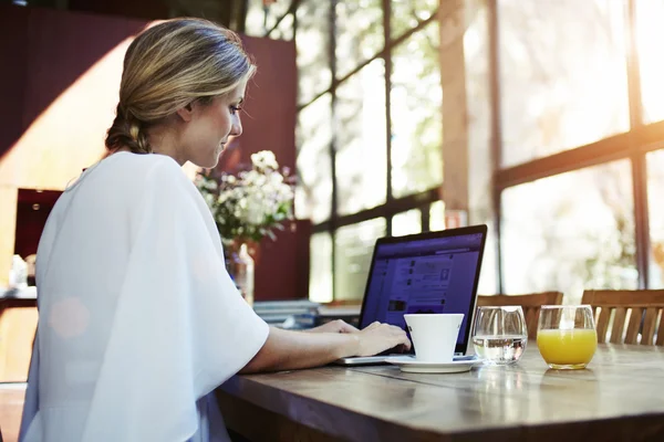 Beautiful young woman working on net-book — Stok fotoğraf