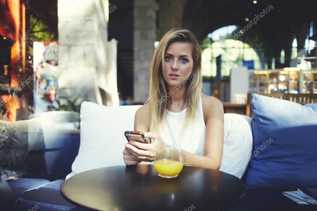 Attractive hipster girl waiting for a call