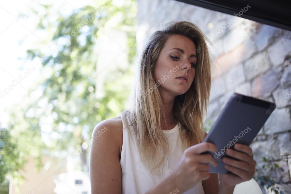 Charming woman using digital tablet