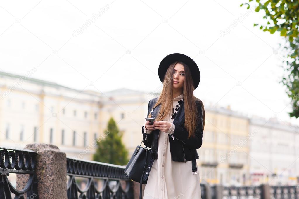 Woman with mobile phone walking on the street