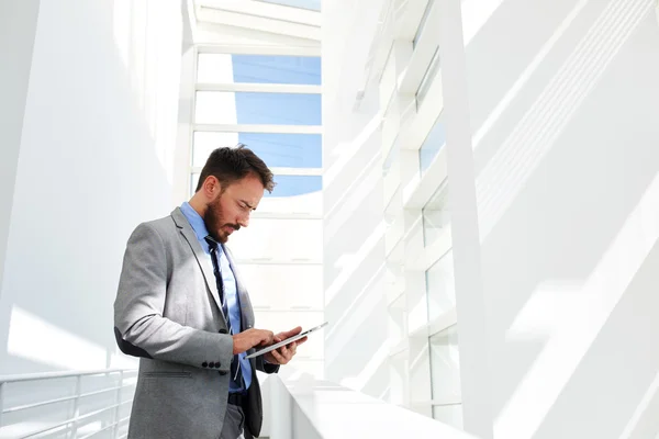 Businessman working on touch pad in office