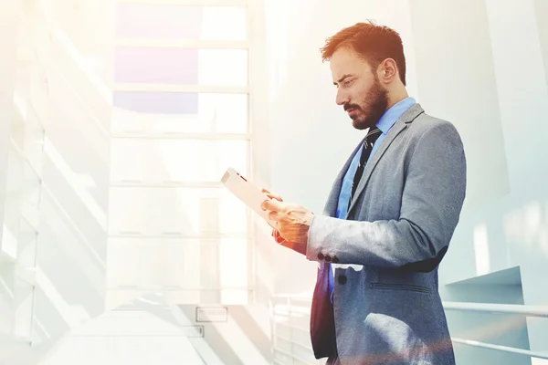 Businessman working on touch pad in office