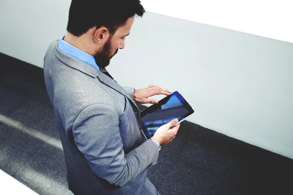 Businessman working on touch pad in office