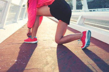 Woman tying the lace on running shoes