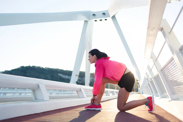 Woman tying the lace on running shoes — 스톡 사진