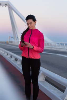 Sportswoman using smart phone
