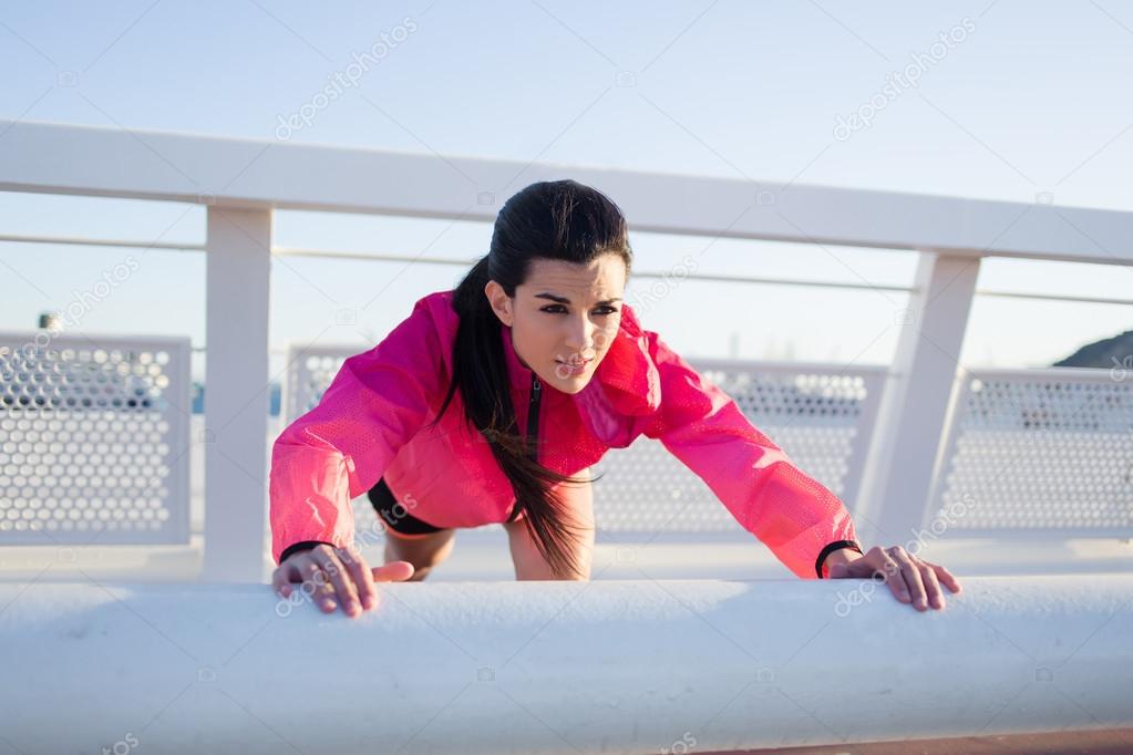 Fit woman doing push-ups exercises