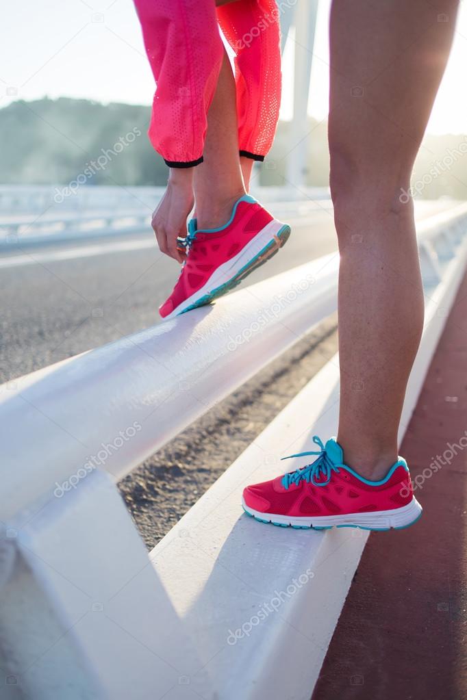 Woman tying the lace on running shoes