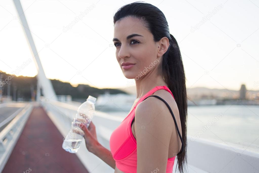Athletic woman holding bottle of water